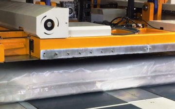 A machine that compresses the mattress from 10" to 1" thick